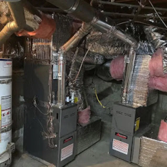Two furnaces with new ductwork in a garage