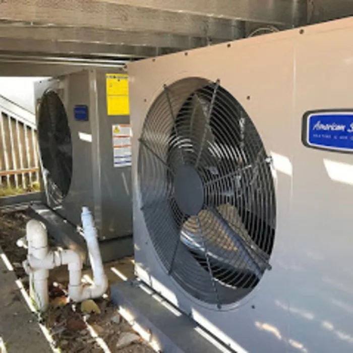 Heat pump outdoor unit installed next to a home