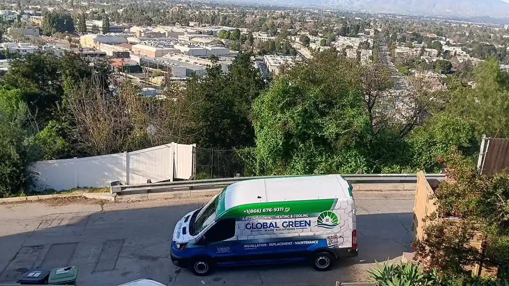 Global Green HVAC Solutions service van on a road above the city