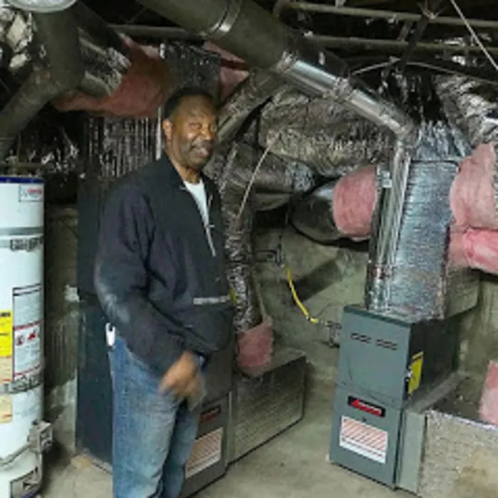 Technician beside two newly installed furnaces