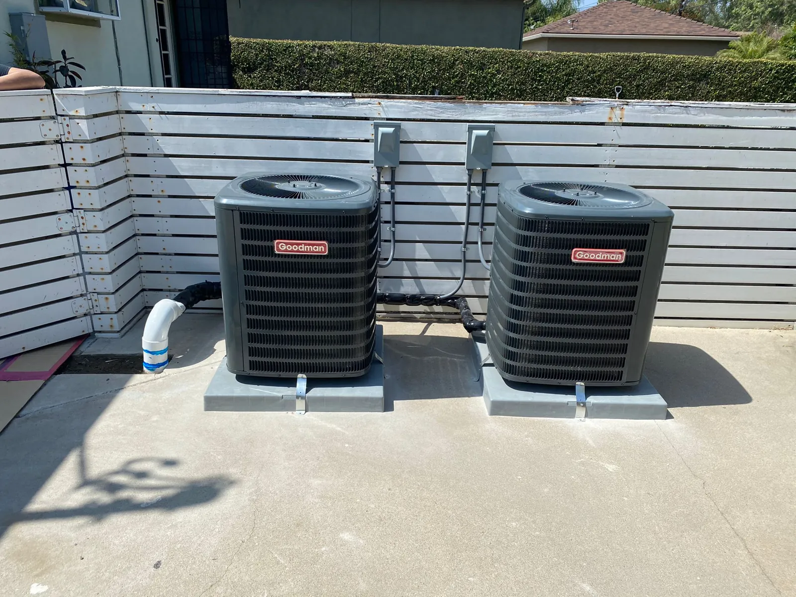 Two new air conditioning condensers on a patio
