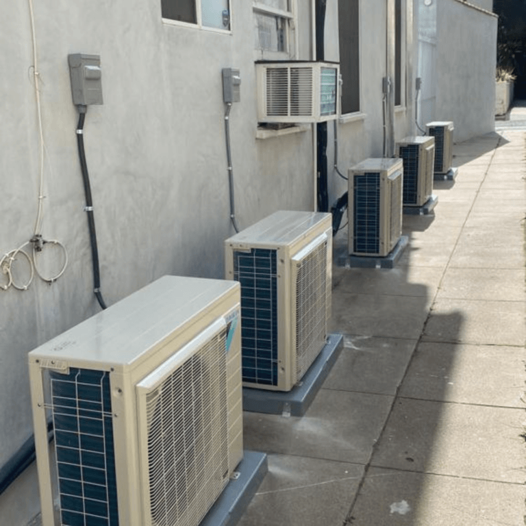 Row of ductless outdoor units along a building wall