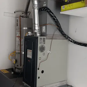 Gas furnace installed next to a water heater in a closet