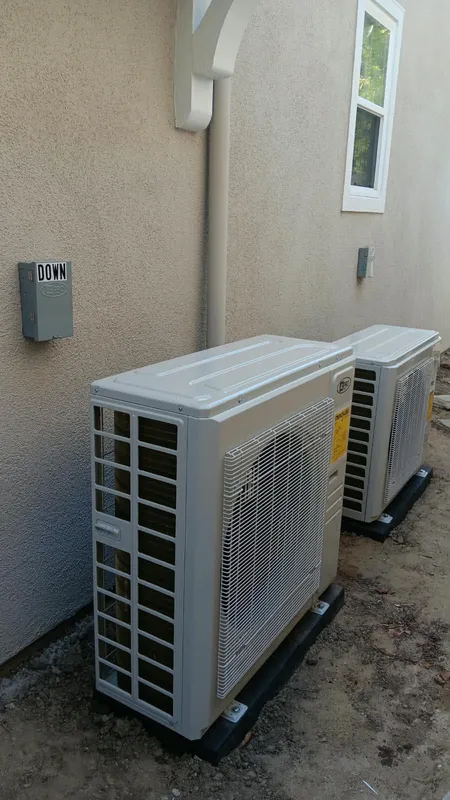 Pair of outdoor HVAC units installed along the side yard of a Pasadena home